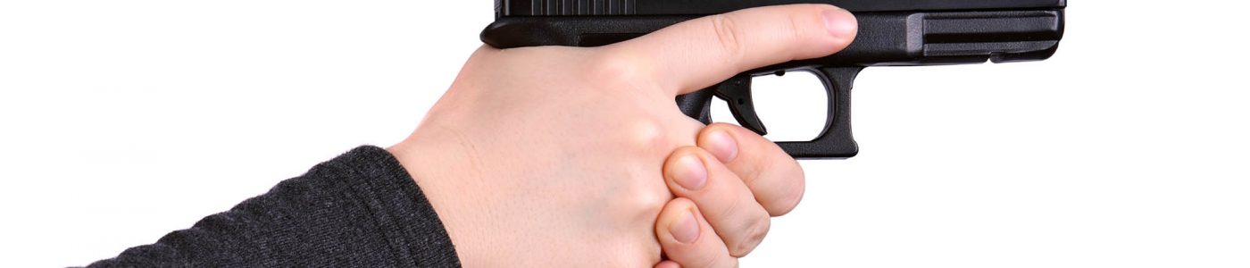Close up of female hands aiming gun on a white background
