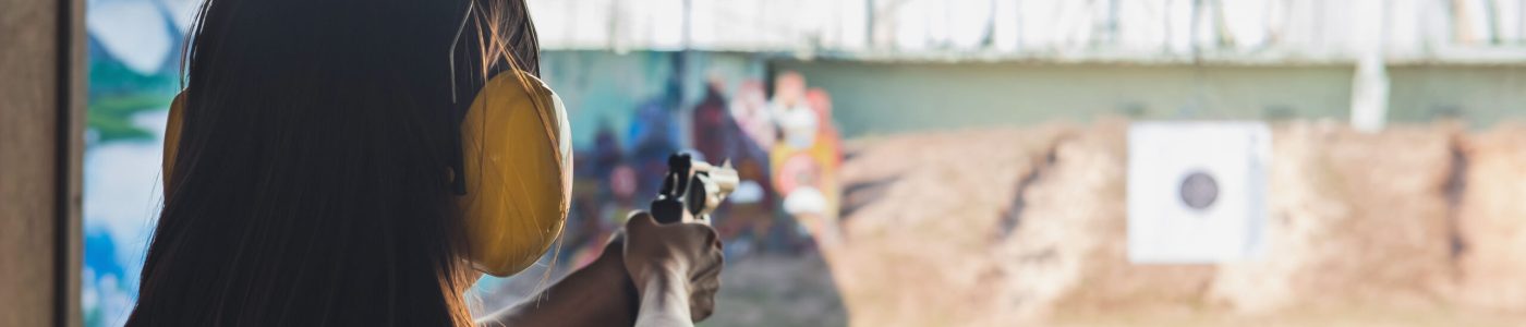 Young woman practice gun shoot on target